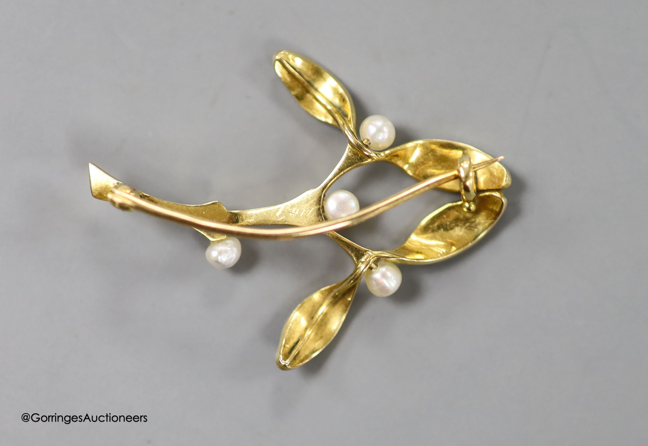 An Art Nouveau yellow metal, green enamel and seed pearl set foliate brooch, 38mm, gross weight 5.2 grams.